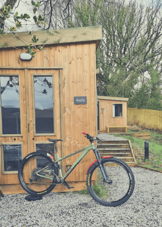 A cabin with a mountain bike stood outside it ready for adventuring