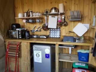 Everything you need for a functional kitchen: sink, fridge, microwave, crockery and pots and pans.