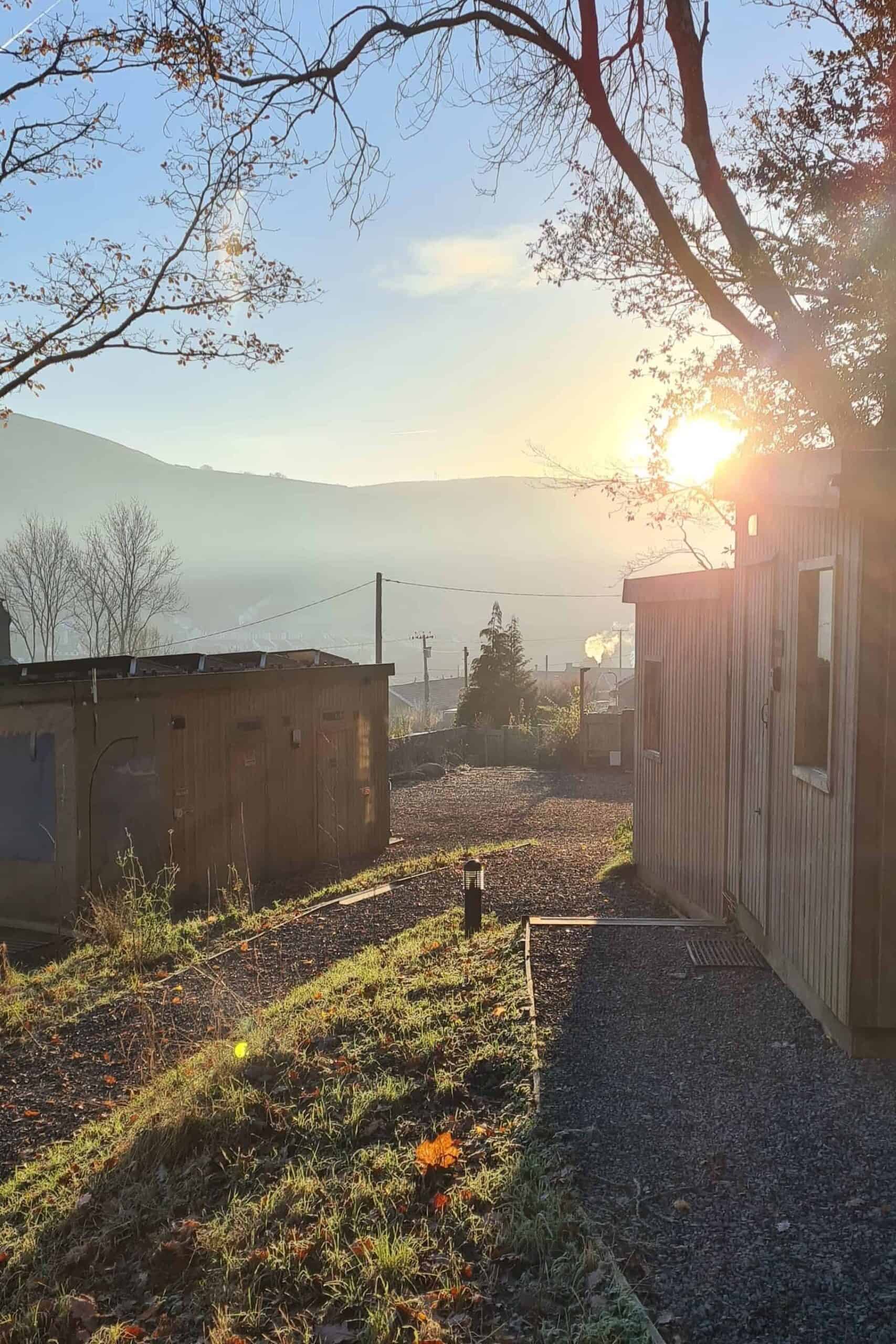 The sun coming up over a hill